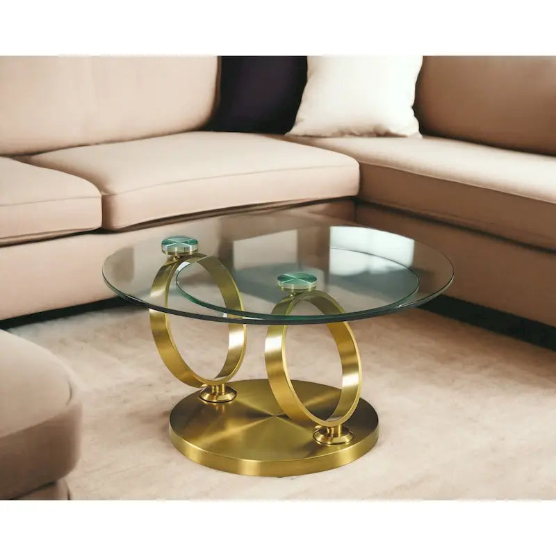 Runder Couchtisch mit transparenter Glasplatte und ringförmigem Untergestell aus Goldmetall
